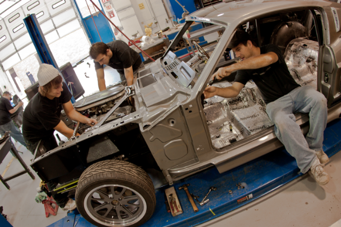 automotive students working on a car